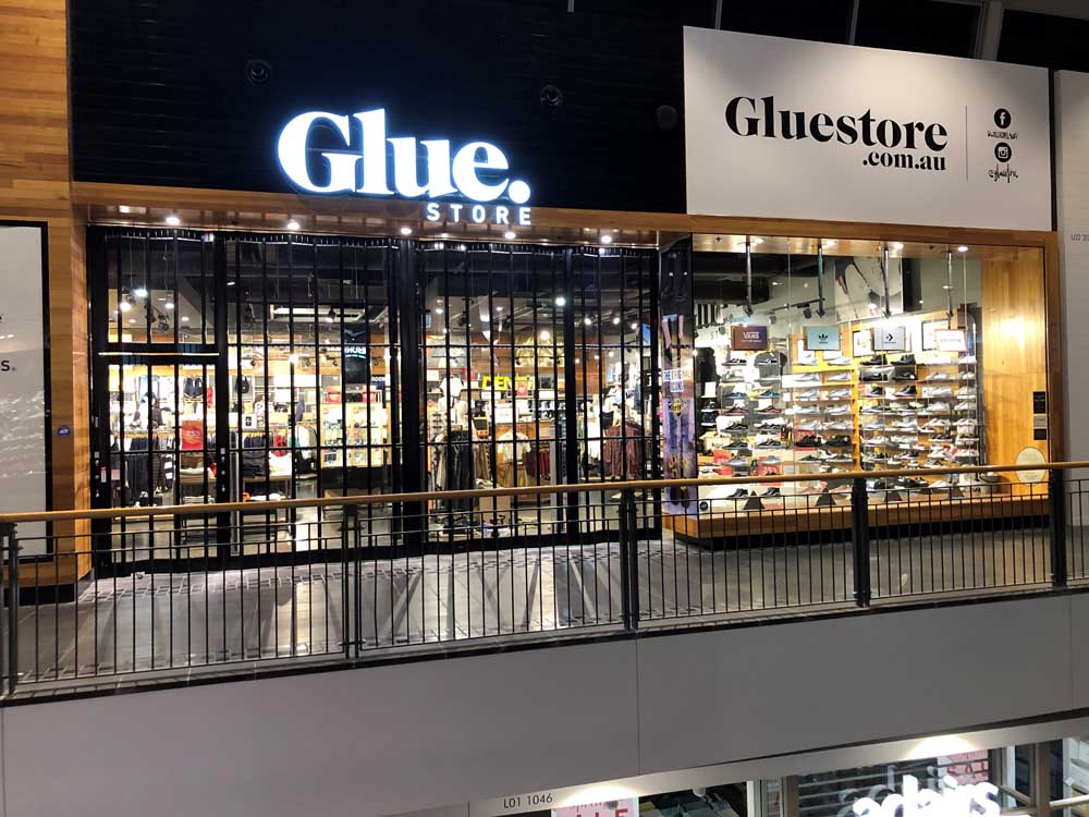 ATDC's black powdercoated folding closure doors at Glue Store