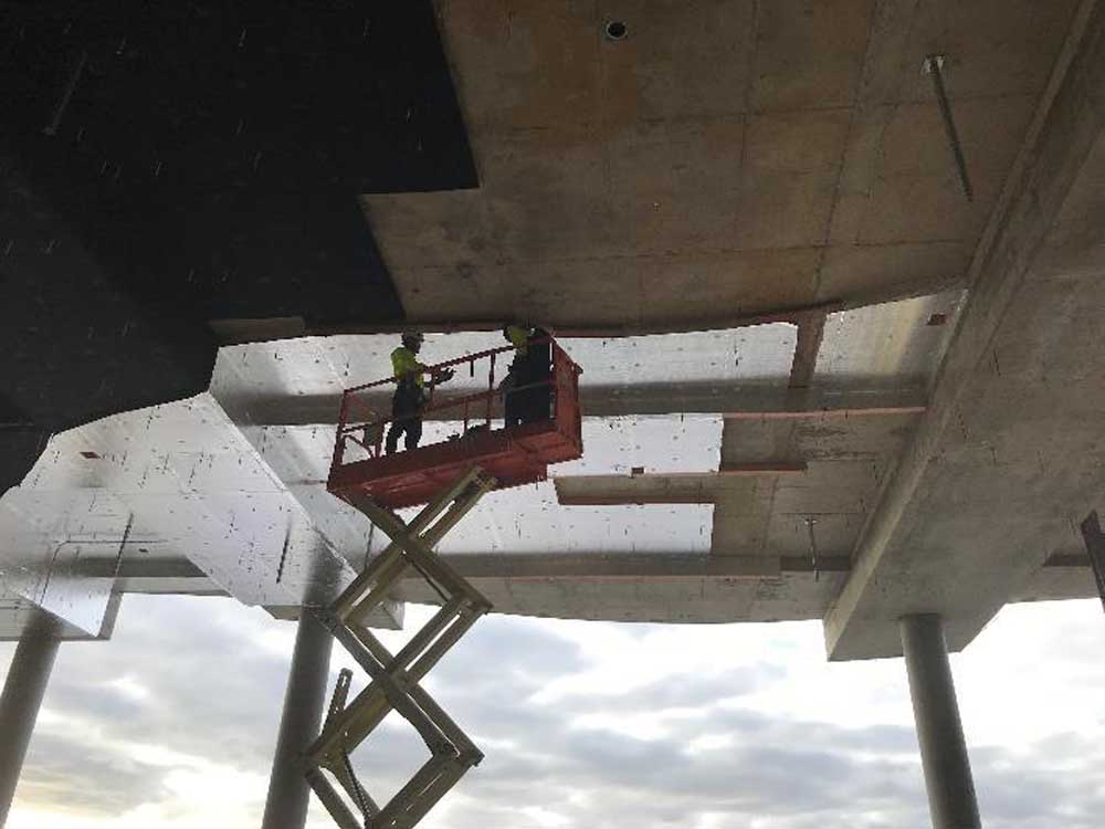 Rigid soffit insulation being installed