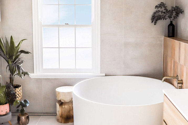 round white bath in bathroom with plant small