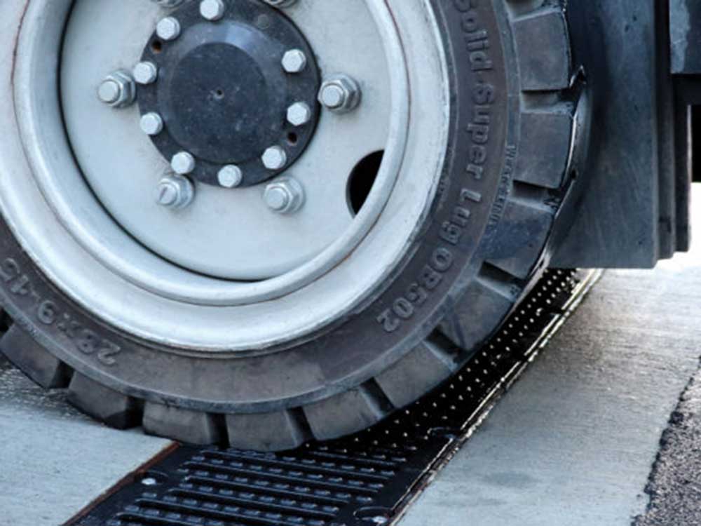 A forklift wheel safely goes over a Polymer Concrete channel